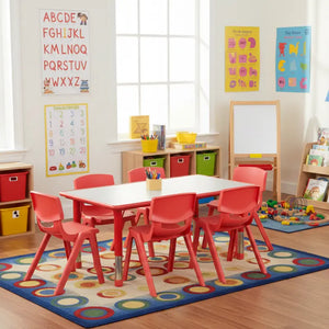 Children's classroom with red tables and chairs, colorful posters, and toys.