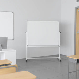 Whiteboard in a classroom setting with desks and a computer.